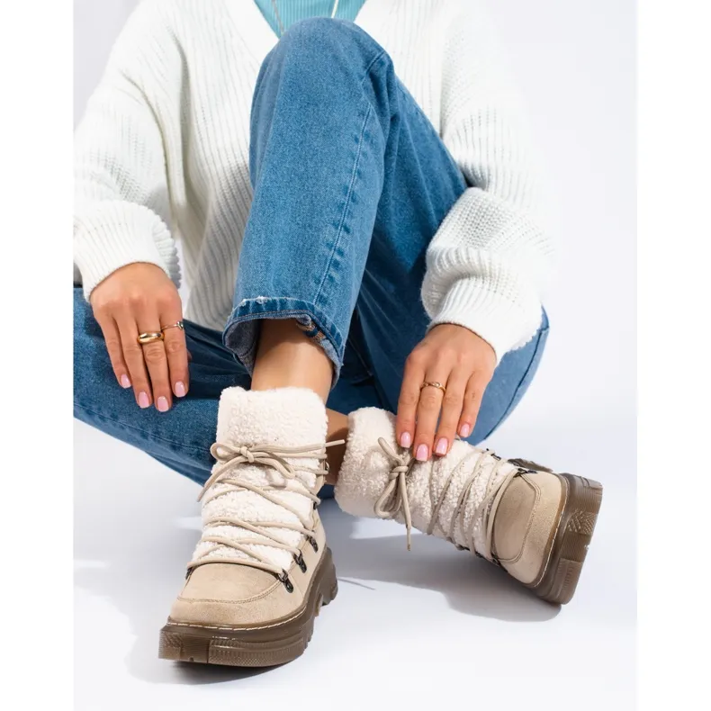 Women's beige snow boots with a sheepskin coat