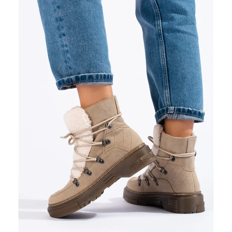 Women's beige snow boots with a sheepskin coat